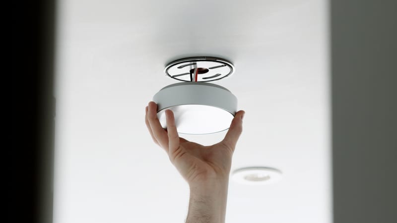 Phare C1 smoke alarm mounted on a wall, angled view